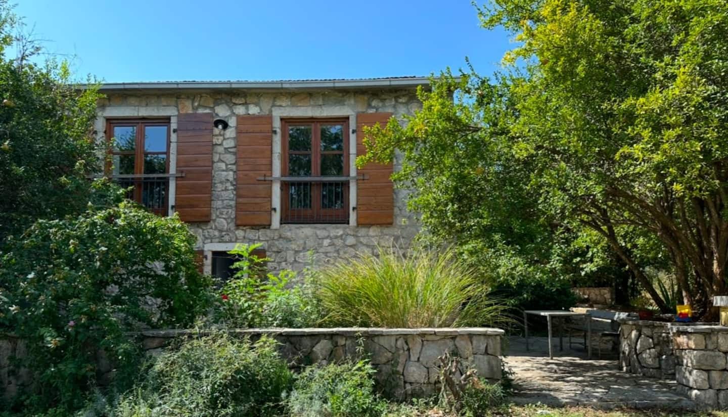 The Winemaker's House at Jablan Winery — a 300-year-old stone house with wooden shutters and a garden terrace